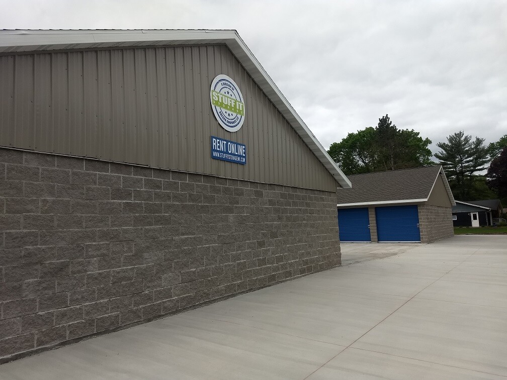 Stuff it Storage building with a Rent Online sign and blue roll-up doors