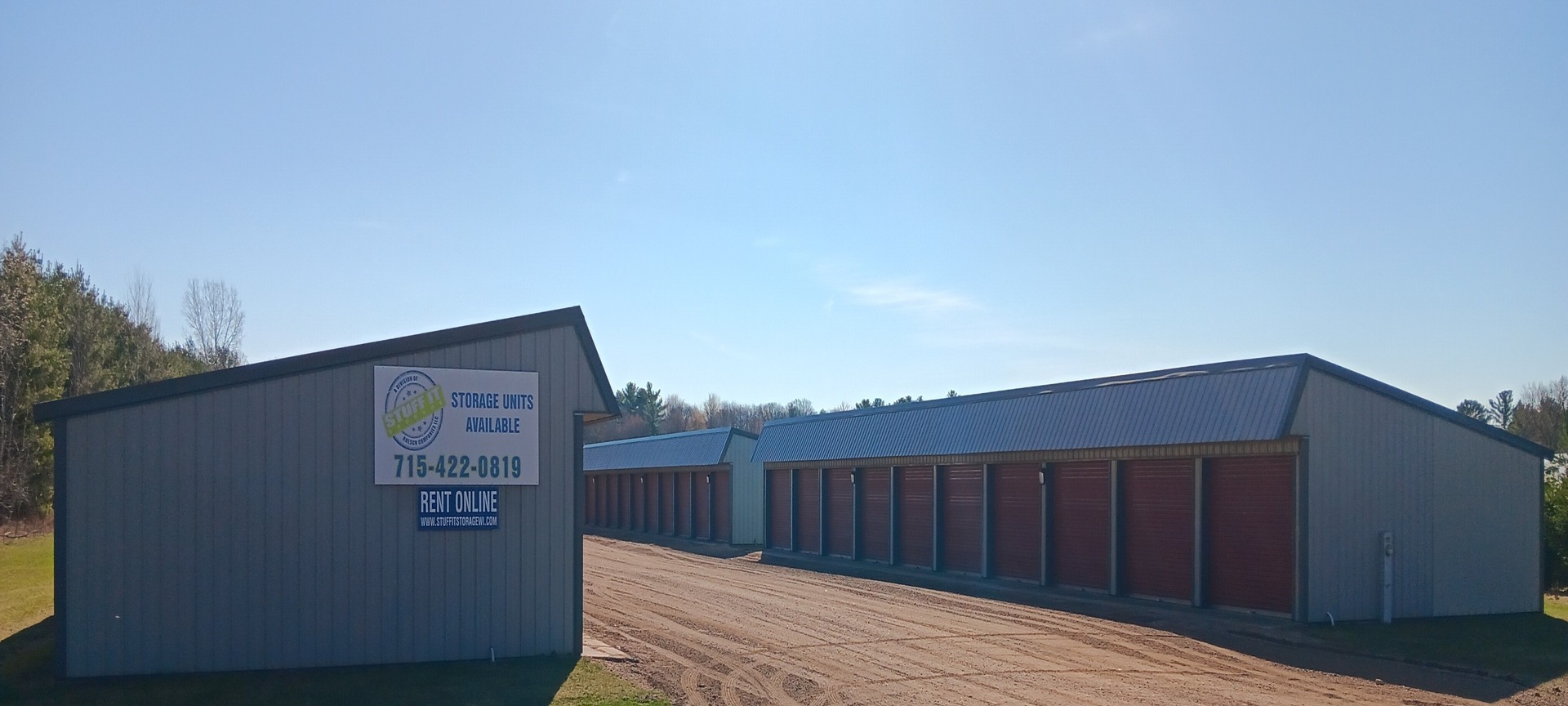 Port Edwards storage buildings with red roll-up doors and a Storage Units Available sign