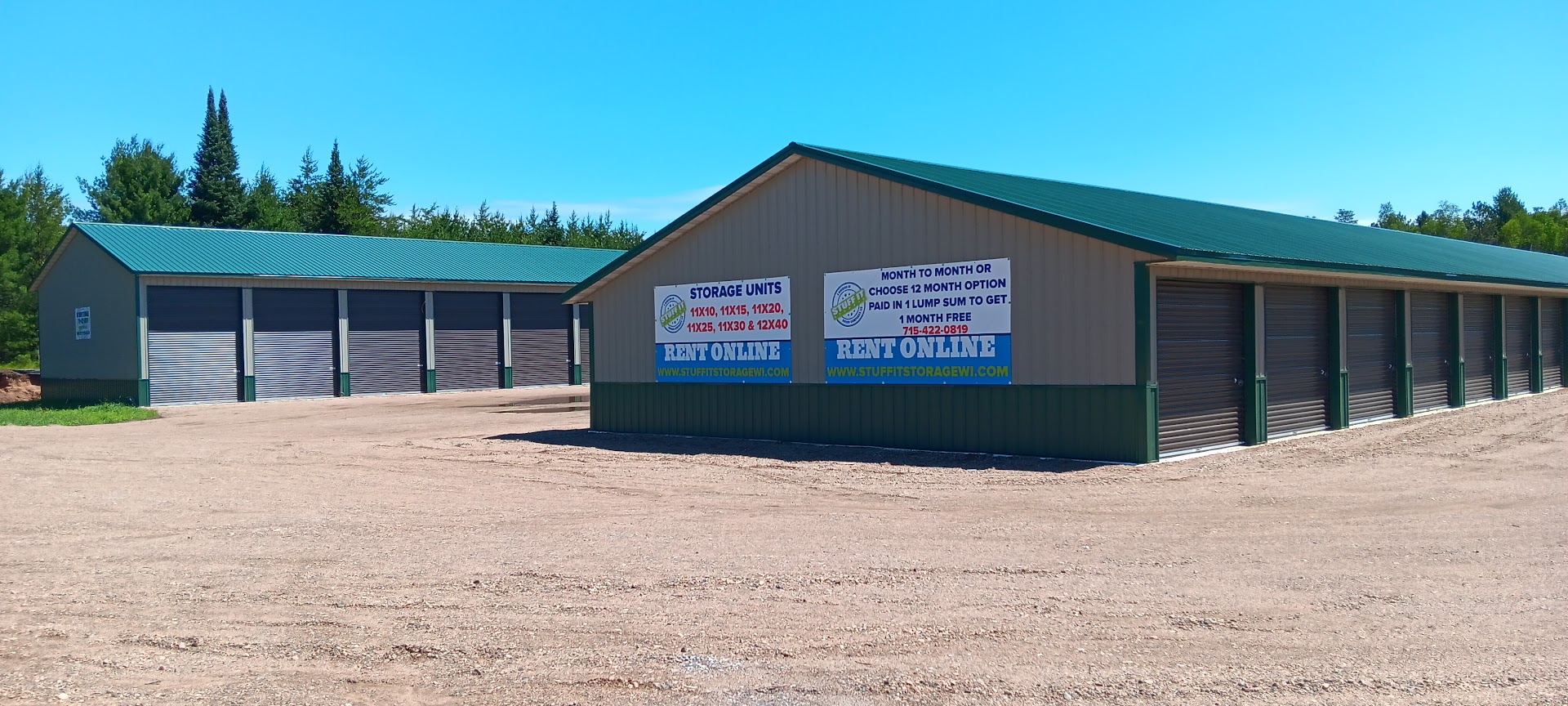 Woodruff storage buildings with green roofs, pine trees and Rent Online signs